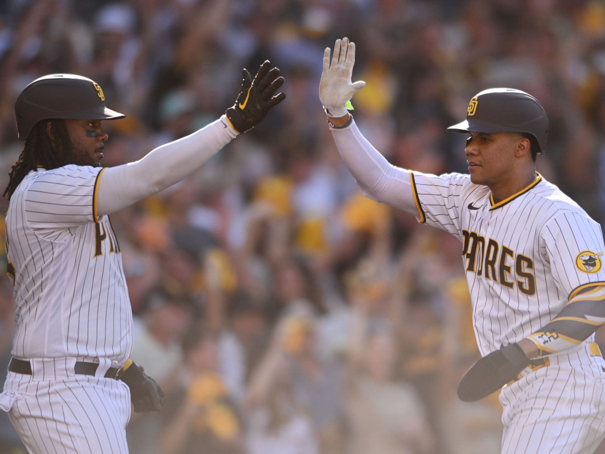 Padres DH Josh Bell congratulates Juan Soto on scoring a run in Game 2 of the 2022 NLCS.
